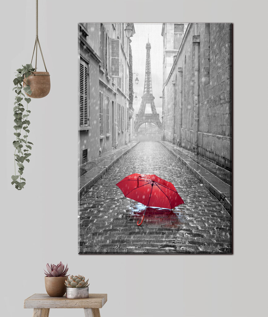 A red umbrella in a street with a tower in the background