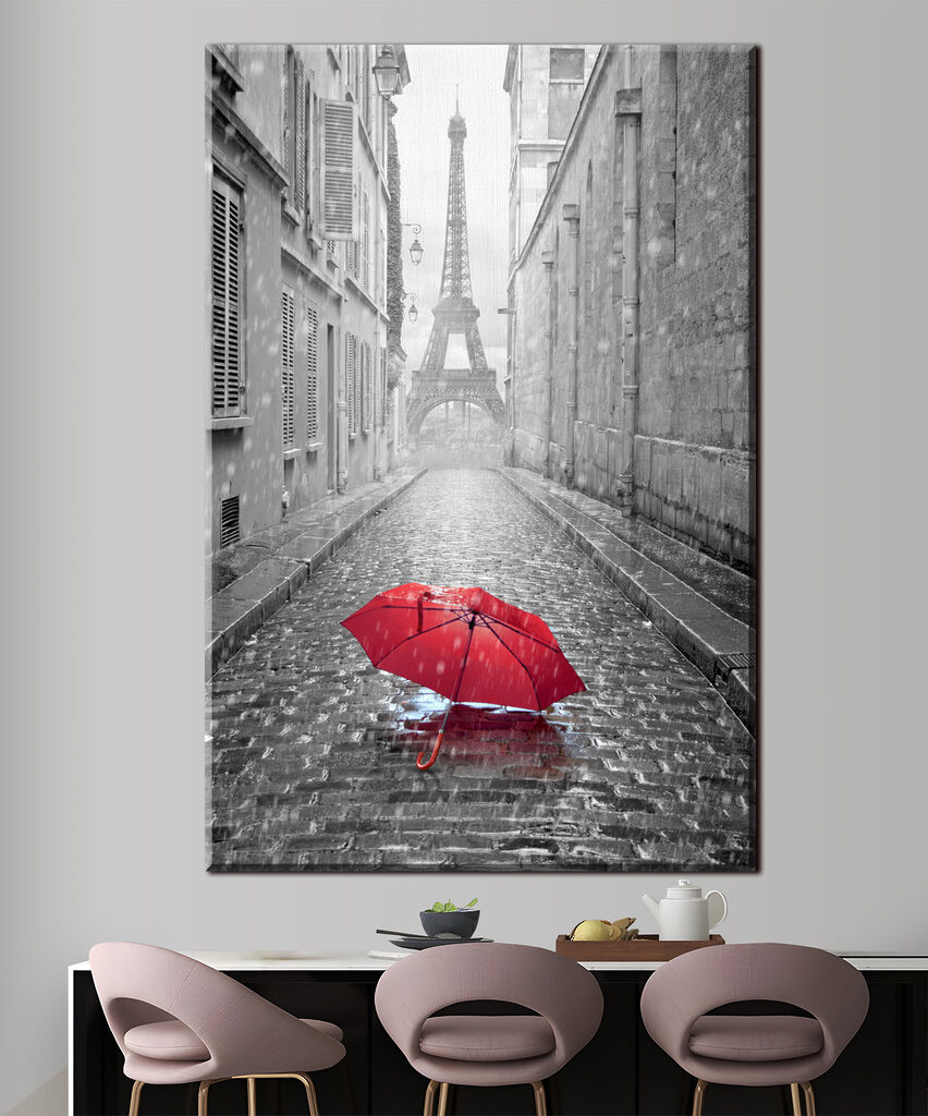 A red umbrella in a street with a tower in the background