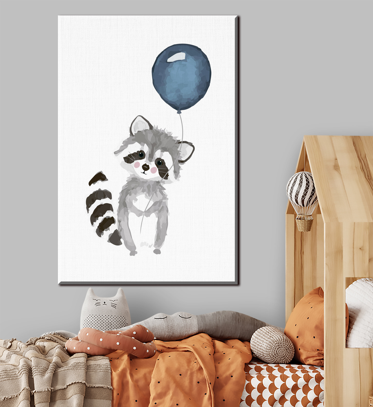 A raccoon holding a balloon