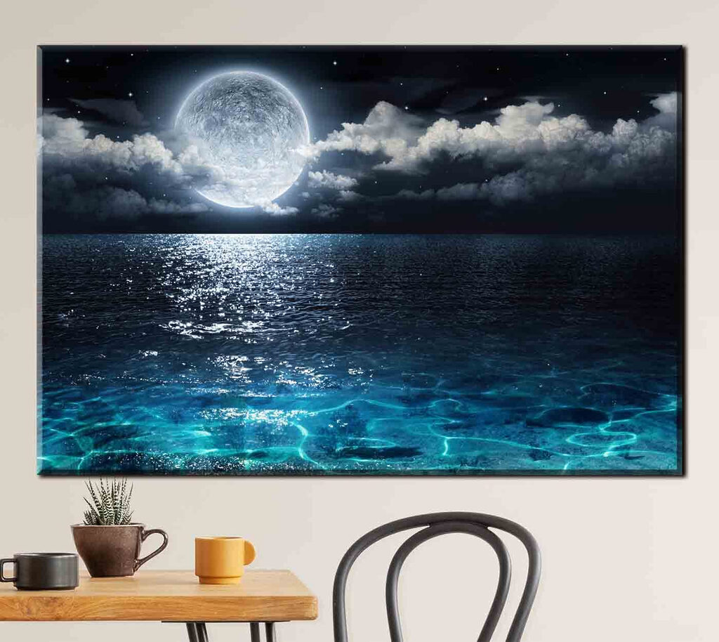 A moon over water at night