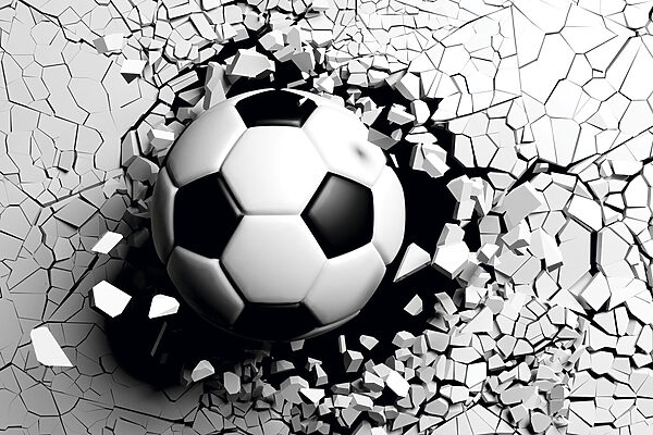 Een voetbal die door een muur breekt Een voetbal die door een muur breekt