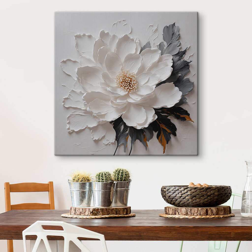 A white flower with black and grey leaves