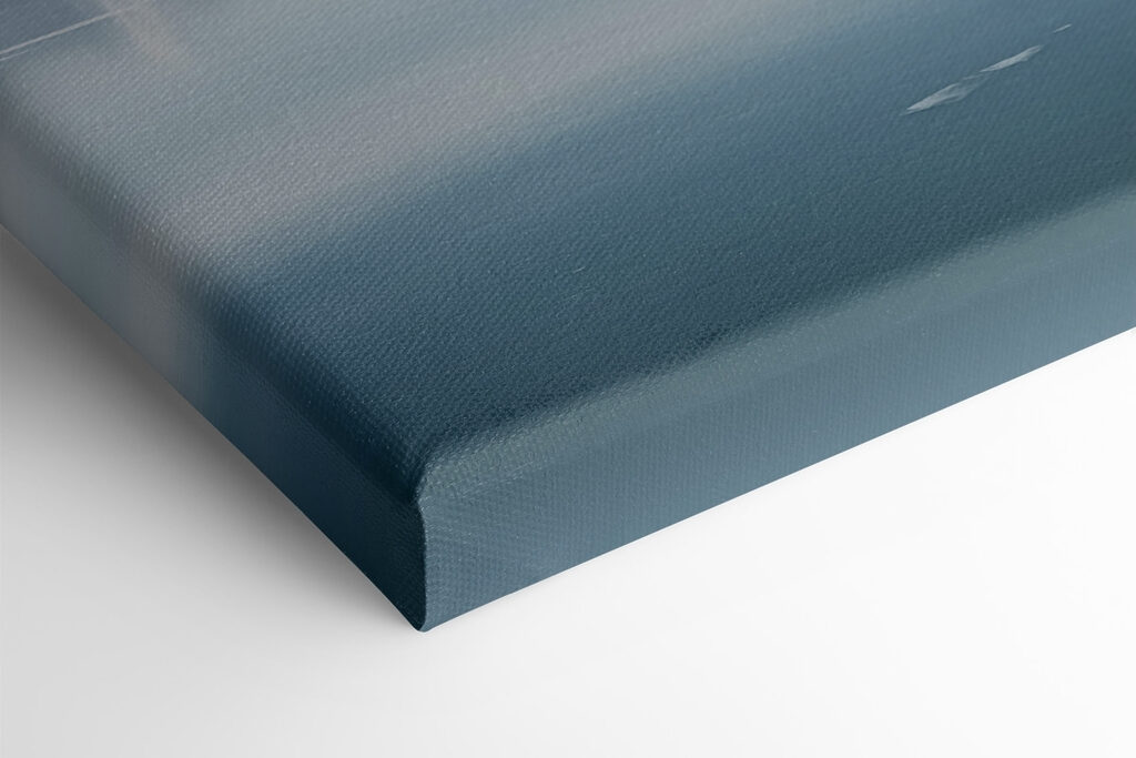 Red house on an island in water with snow covered mountains in the background