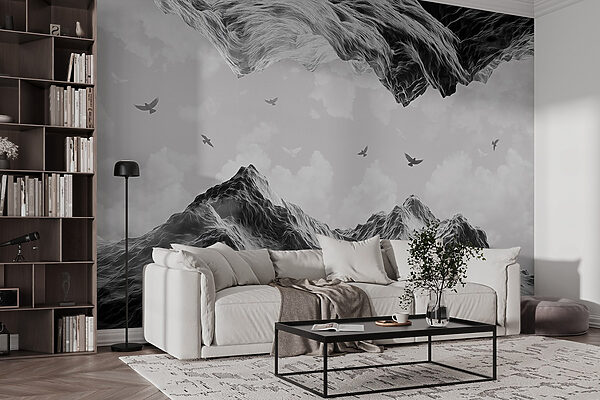 Group of birds flying over a mountain