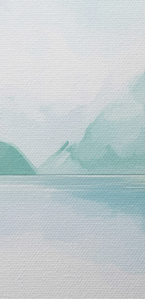 Water with trees and mountains in the background