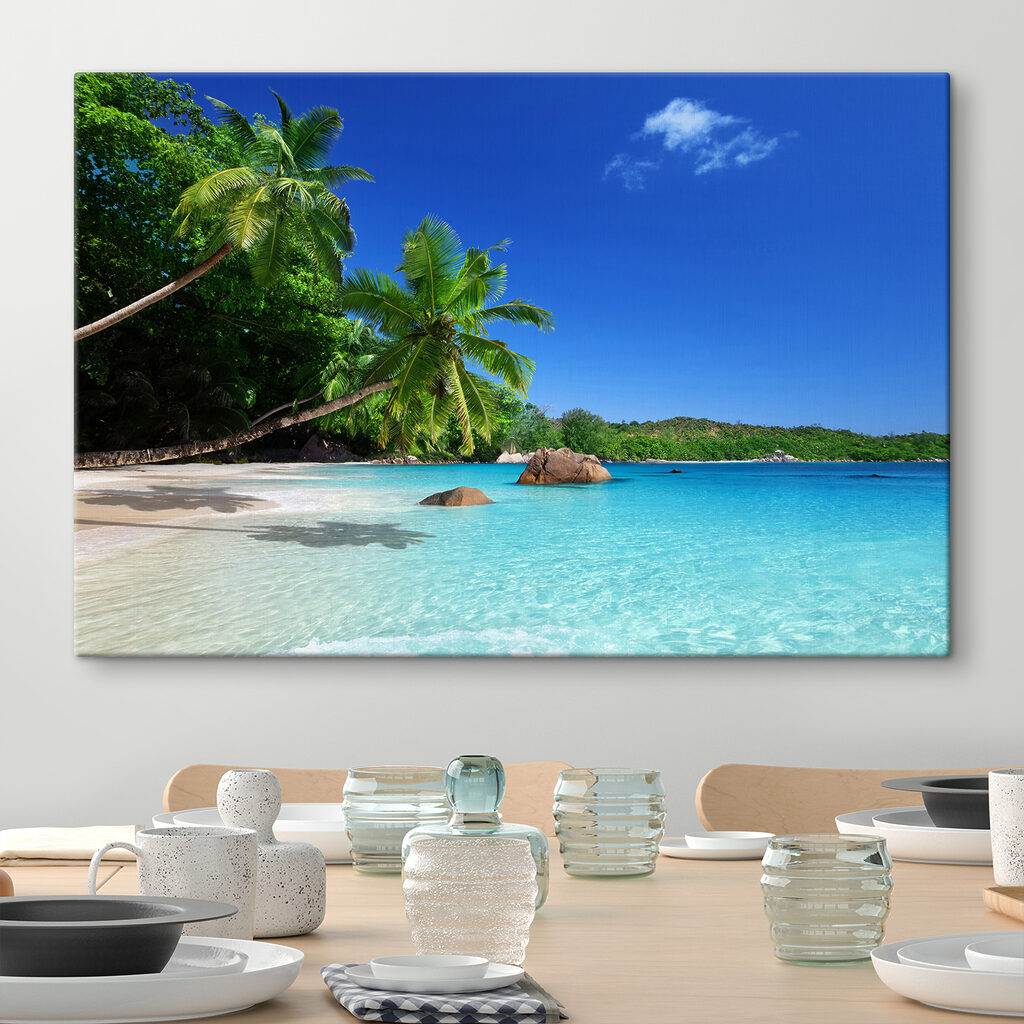 A beach with palm trees and blue water