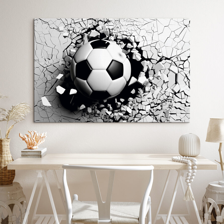 Een voetbal die door een muur breekt