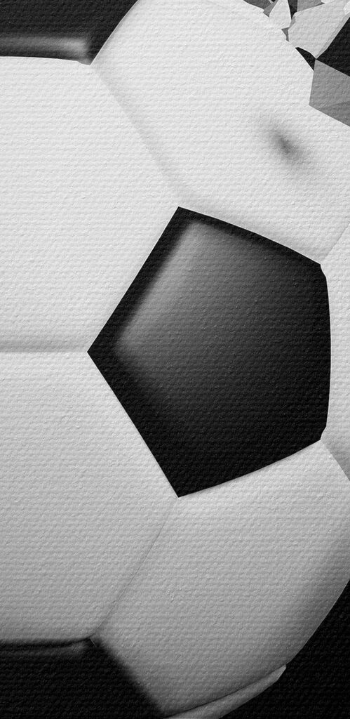 A football ball breaking through a wall