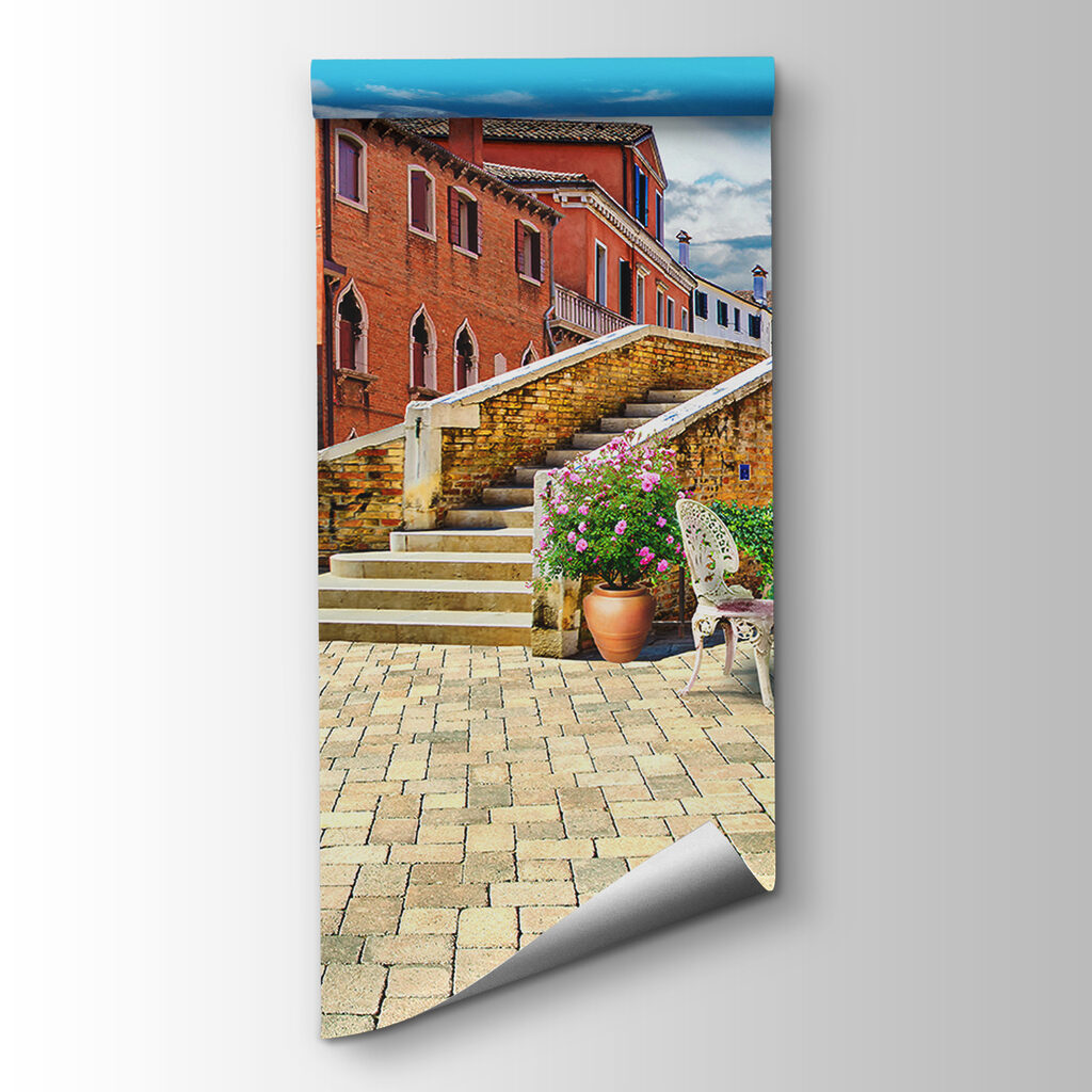 Patio with a table and chairs and a fountain in front of a building Patio with a table and chairs and a fountain in front of a building