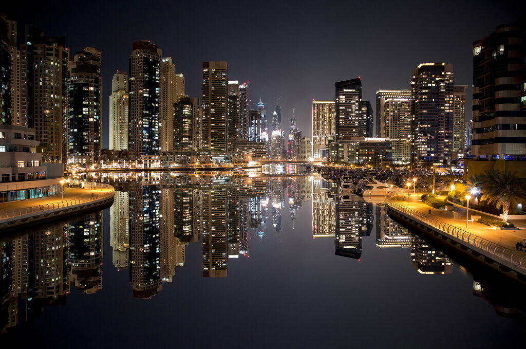 City skyline with lights reflecting on water