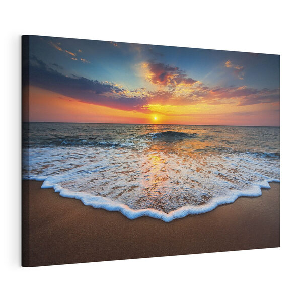 Canvas Schilderijen Een zonsondergang boven een strand