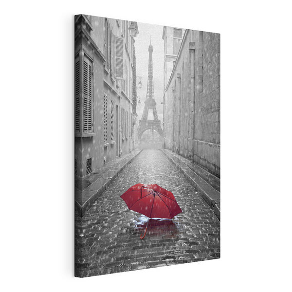 Een rode paraplu in een straat met een toren op de achtergrond Canvas Schilderijen Een rode paraplu in een straat met een toren op de achtergrond