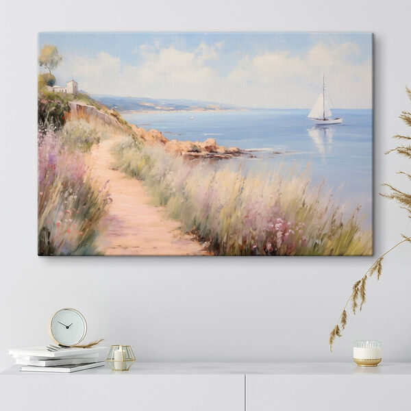 Path leading to a body of water with a sailboat